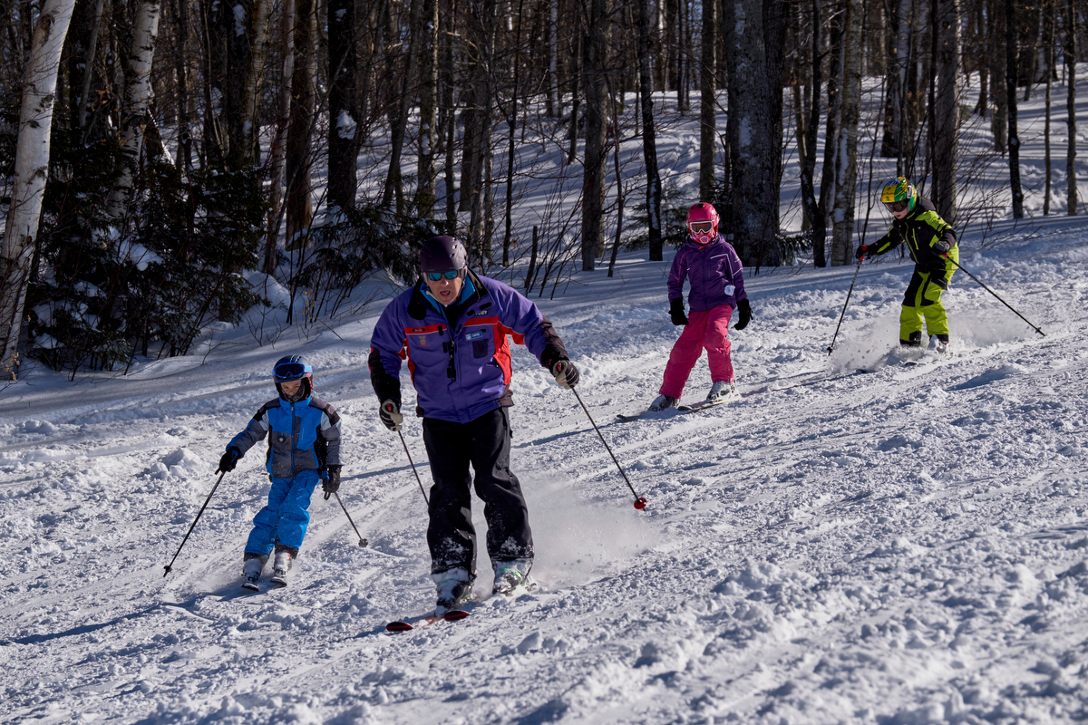 Ski instructors at the Middlebury College Snow Bowl lead a class for kids